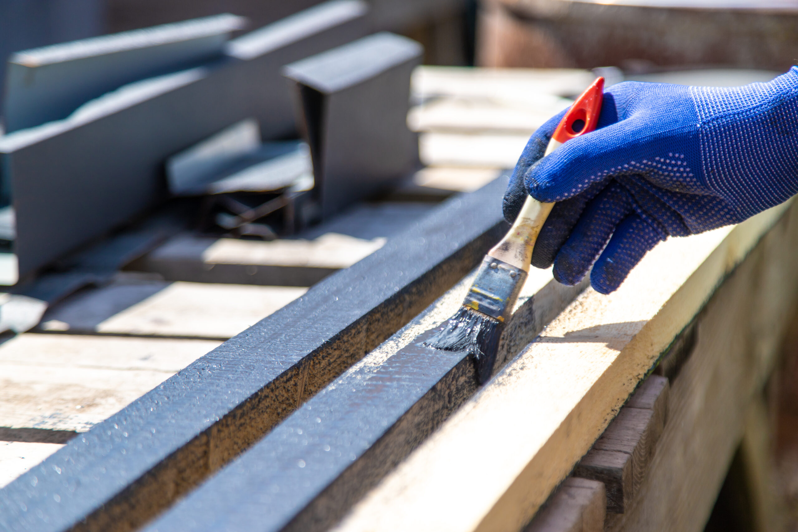 A man paints a board with paint. Selective focus. nature.